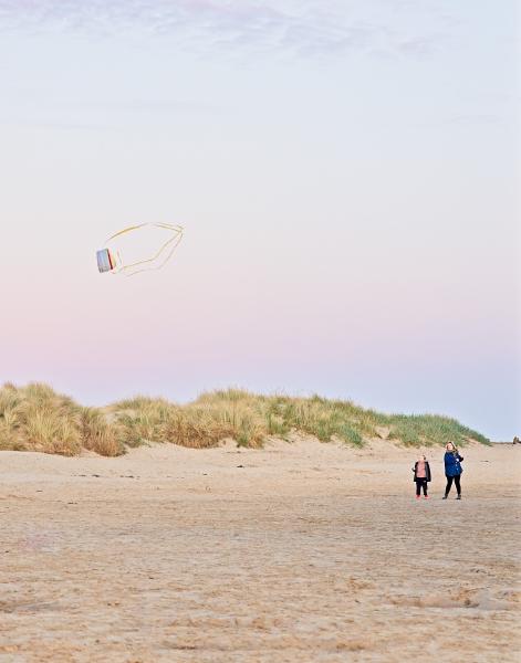 Back on the Northumberland coast, a mother and daughter flying a kite at sunset, the kite was dancing across the sky, I wonder what they were trying to spell.