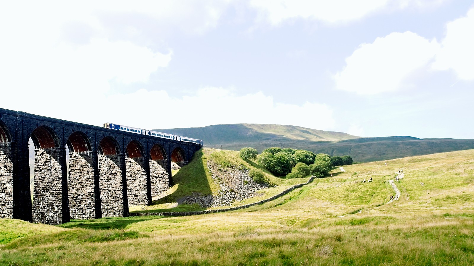 A train heads off towards Whernside, just a shame that it wasn't putting out billows of steam, better for the environment though I guess. The stunning Ribblehead viaduct casting shadows across the valley.